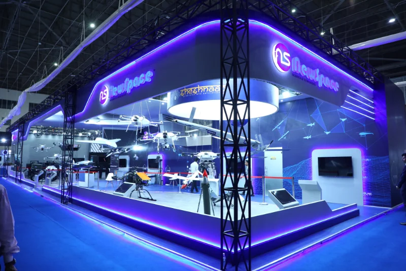 Exhibition hall with branded booths — Aero India 2027 booth design and exhibition stall example by WHTNXT